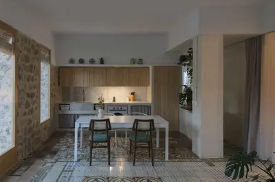 a kitchen with a white table and chairs at Villa Serrano, La casa rural de los mil suelos in Valencia