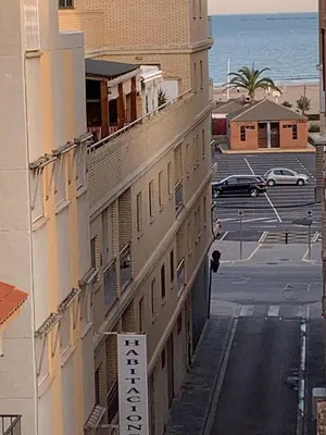 a building with a sign on it next to a parking lot at UIM Mediterraneo Buenavista Wifi in Puerto de Sagunto
