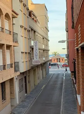 an empty street in a city with buildings at UIM Mediterraneo Buenavista Wifi in Puerto de Sagunto