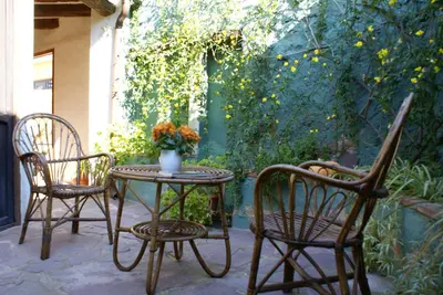 two chairs and a table on a patio at Casa de Pueblo El Patio de las Cebollas in Segorbe