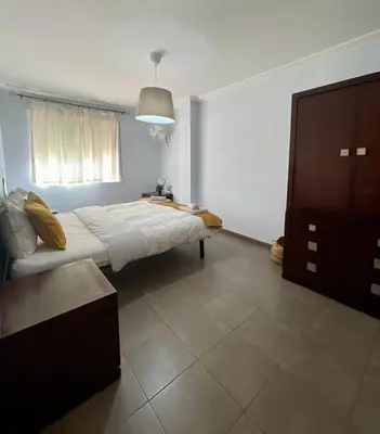a bedroom with a bed and a dresser in it at UIM Mediterraneo Churruca Wifi in Puerto de Sagunto