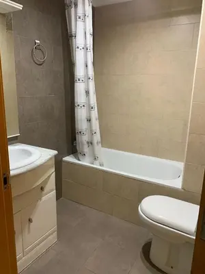 a bathroom with a tub and a toilet and a sink at UIM Mediterraneo Churruca Wifi in Puerto de Sagunto