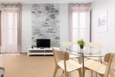 a kitchen with red cabinets and a washer at Adarve Flats in Valencia