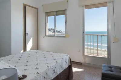 a bedroom with a bed and a view of the ocean at El Raco, A-7-13 in Cullera