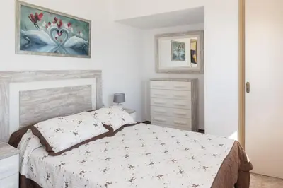 a bedroom with a bed and a painting on the wall at El Raco, A-7-13 in Cullera