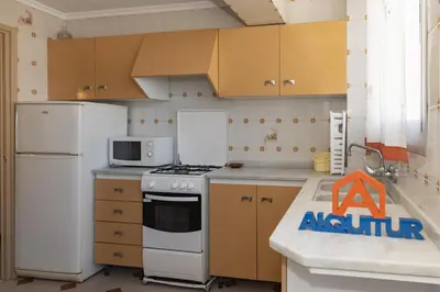 a kitchen with a white stove and a refrigerator at El Raco, A-7-13 in Cullera