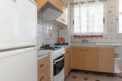 a kitchen with a white stove top oven next to a sink at El Raco, A-7-13 in Cullera