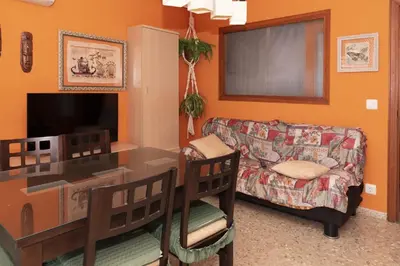 a living room with a table and a couch at Nereidas, A-2, 1-2 in Cullera