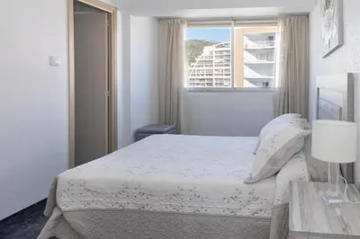 a white bedroom with a bed and a window at El Raco, B-8-15 in Cullera