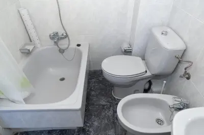a bathroom with a toilet and a tub and a sink at El Raco, B-8-15 in Cullera