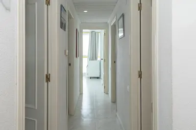 a hallway with white walls and white floors at Florazar-3, 14-E in Cullera