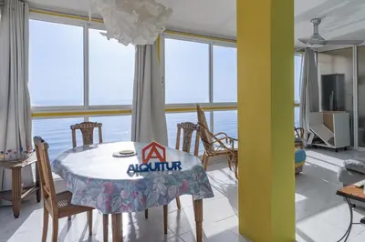 a dining room with a table and some windows at Florazar-3, 14-E in Cullera
