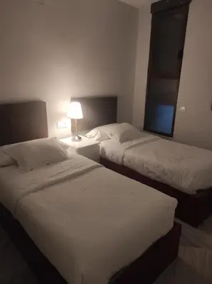 a hotel room with two beds and a lamp at APARTAMENTOS En Plom in Valencia