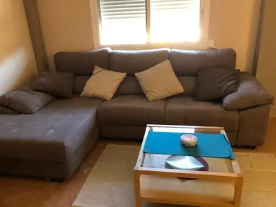 a brown couch with a coffee table in a living room at CASA MANUELA in Chella