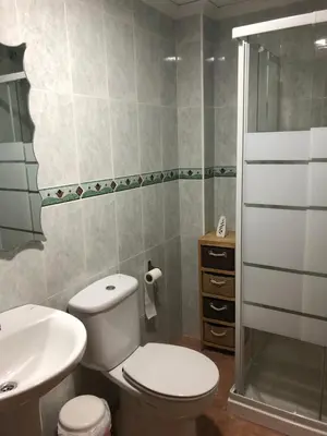 a bathroom with a toilet and a sink and a shower at CASA MANUELA in Chella
