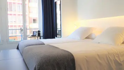 a bedroom with a large bed with a large window at PLAZA VIEW in Valencia