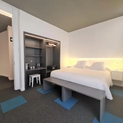 a bedroom with a large white bed and a desk at PLAZA VIEW in Valencia