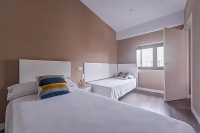 a bedroom with a large white bed and a window at San Miguel, Luxury apartments. in Valencia