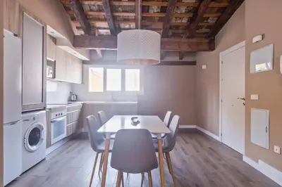 a kitchen and dining room with a table and chairs at San Miguel, Luxury apartments. in Valencia