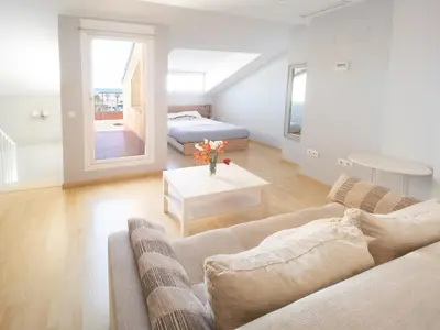 a living room with a couch and a bed at Valencia Beach Apartments 2 in Valencia