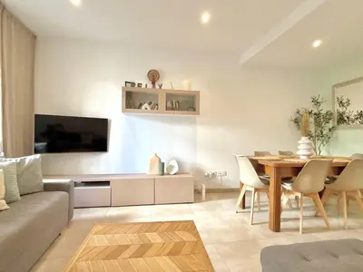 a living room with a table and a couch at Apartamento Playa Valencia Beach in Valencia