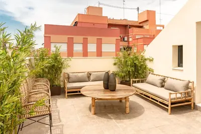 a patio with couches and a table and chairs at Valencia Luxury - Sea Port I in Valencia