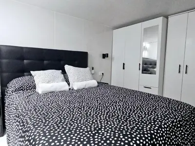 a bedroom with a black and white bed with two pillows at A6 ViviendaTuristicaValencia Ciencias in Valencia
