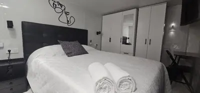 a bedroom with a white bed with towels on it at A6 ViviendaTuristicaValencia Ciencias in Valencia
