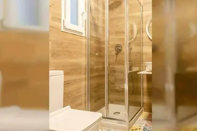 a bathroom with a toilet and a glass shower at Valencia Playa in Valencia