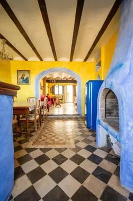 a room with a checkered floor and a dining room at Casa Museo RAKKANA - En el Centro de Requena in Requena