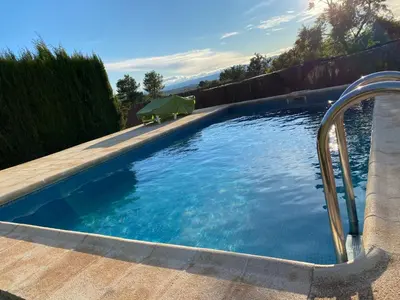 a swimming pool with blue water in a yard at Villa Barby in Lliria