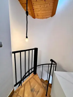 a stairway with a black railing and a ceiling at Casa del Carmen in Valencia