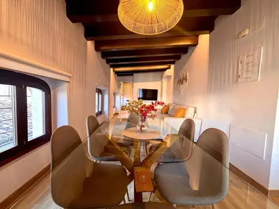 a living room with a white couch and a tv at Casa Valencians in Valencia