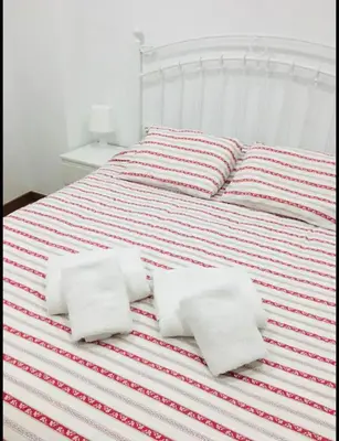 a white bed with four pillows on it at Estudio en el Corazón de Valencia al lado Catedral in Valencia