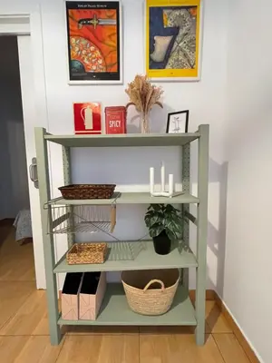 a green shelf in a room with baskets and candles at 2 Apartamento TERRAZA Free Wifi in Valencia