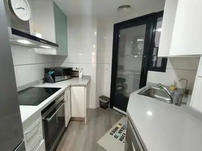 a small kitchen with white counters and a sink at NON STRESS First Level in Valencia