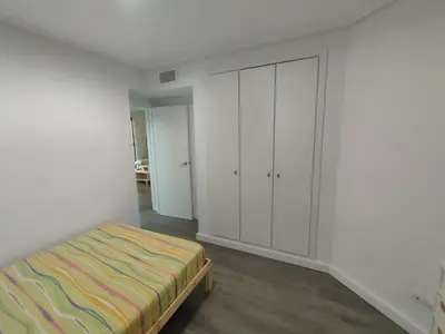 a bedroom with a bed and white cabinets at NON STRESS First Level in Valencia