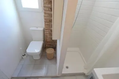 a small bathroom with a toilet and a shower at Piso en el Carmen cerca del Mercado Central in Valencia