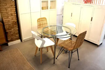 a glass table and four chairs in a room at Piso en el Carmen cerca del Mercado Central in Valencia