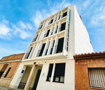 a white building with windows on the side of it at STUDIO Palomar - PalomarGroup in Alfara del Patriarca