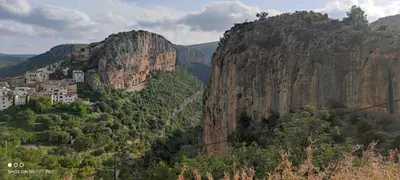 a mountain with a town on top of it at El Enclave in Chulilla