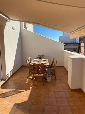 a patio with a table and chairs on a balcony at UIM Mediterraneo ATICO Poeta 8 Wifi in Puerto de Sagunto