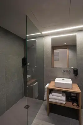 a bathroom with a sink and a glass shower at Dau Studios in Valencia