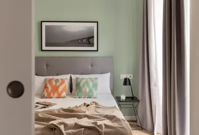 a bedroom with a bed and a picture on the wall at Líbere Valencia Abastos in Valencia
