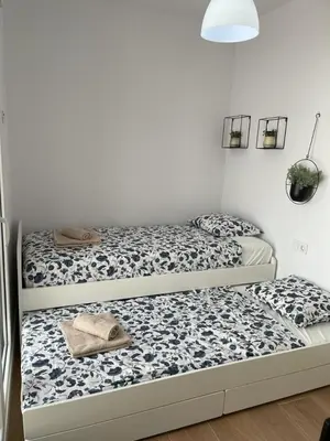 two beds sitting next to each other in a room at UIM Mediterraneo Poeta 5 Wifi in Puerto de Sagunto