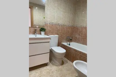 a bathroom with a toilet and a sink and a tub at UIM Mediterraneo Poeta 6 Wifi in Puerto de Sagunto