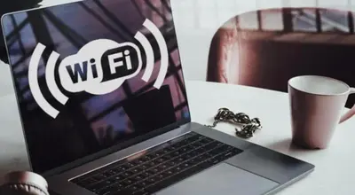 a laptop computer sitting on top of a table with a cup at UIM Mediterraneo Poeta 6 Wifi in Puerto de Sagunto