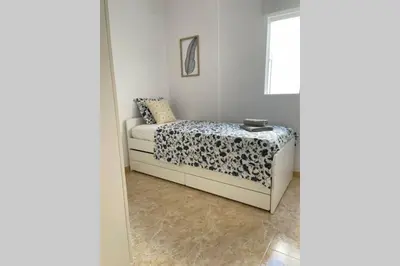 a bedroom with a bed and a window at UIM Mediterraneo Poeta 6 Wifi in Puerto de Sagunto