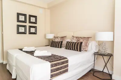 a bedroom with a white bed with two pillows at MD Galán Street in Valencia