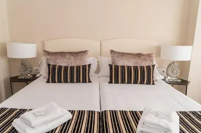 a large white bed with two pillows and two lamps at MD Galán Street in Valencia